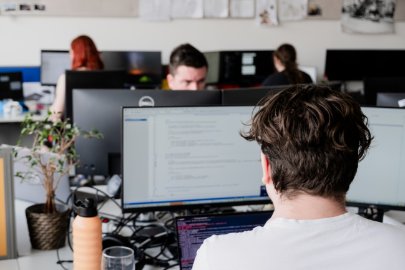 People work with computer screens visible in Kentico's office in Brno.